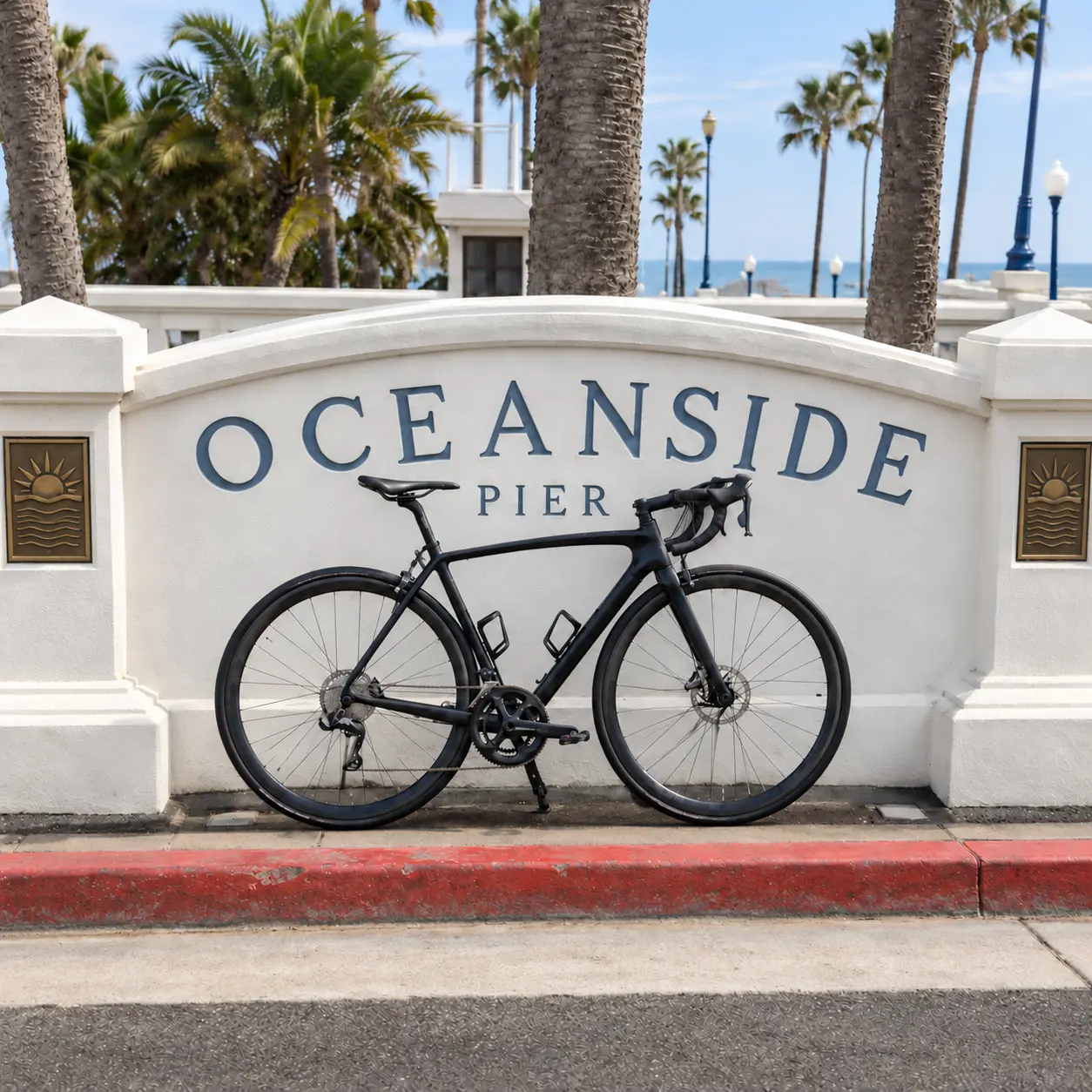Road bicycle parked in front of the Oceanside Municipal Fishing Pier sign